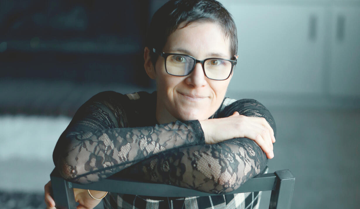 Living Yesfully Photo of Jennilee in black lace shirt smiling into the camera